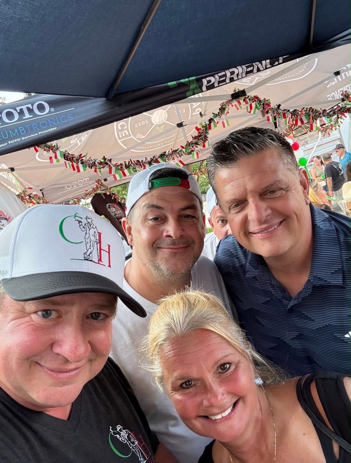 Visitors wearing Cigar House caps at the cigar tent during the Old Town Italian Fest in Bloomingdale