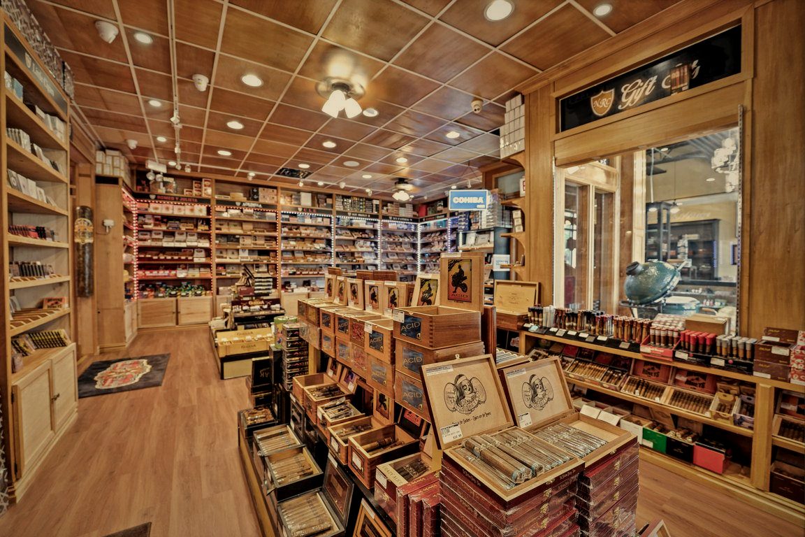 Floor-to-ceiling cigar shelving inside the walk-in humidor at Norwood Royal Cigars